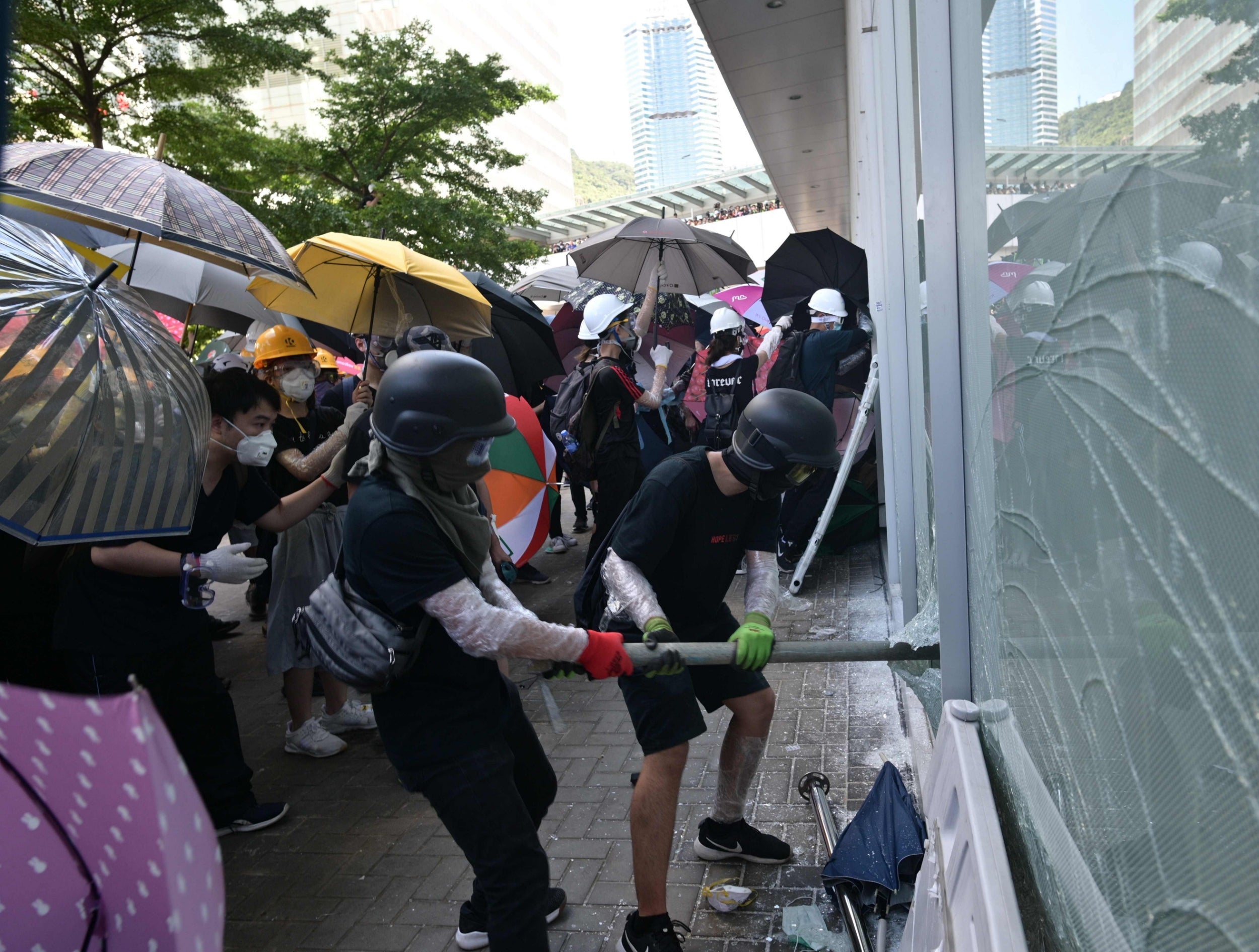 Hong Kong protesters storm government HQ as police officers injured by hurled ‘liquid’