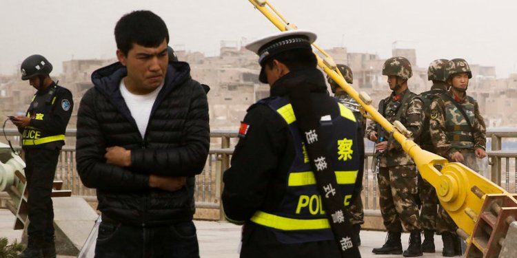 Chinese officials are forcing tourists to install an invasive app that downloads their texts and scans their phones at the border of one of the most surveilled regions in the country