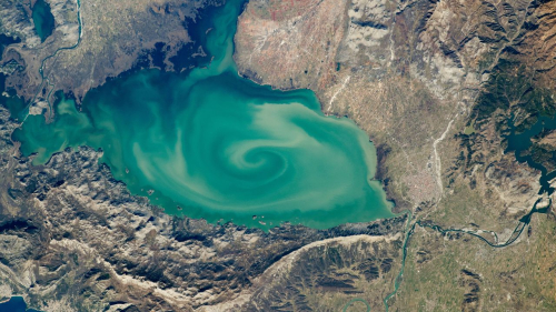 Giant, milky-green vortex swirls across massive ‘cryptodepression’ lake in Southern Europe — Earth from space