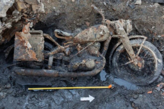 WWII motorcycle and soldiers emerge from river muck in Hungary