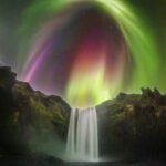 APOD: 2026 August 27 – Colorful Aurora over an Icelandic Waterfall